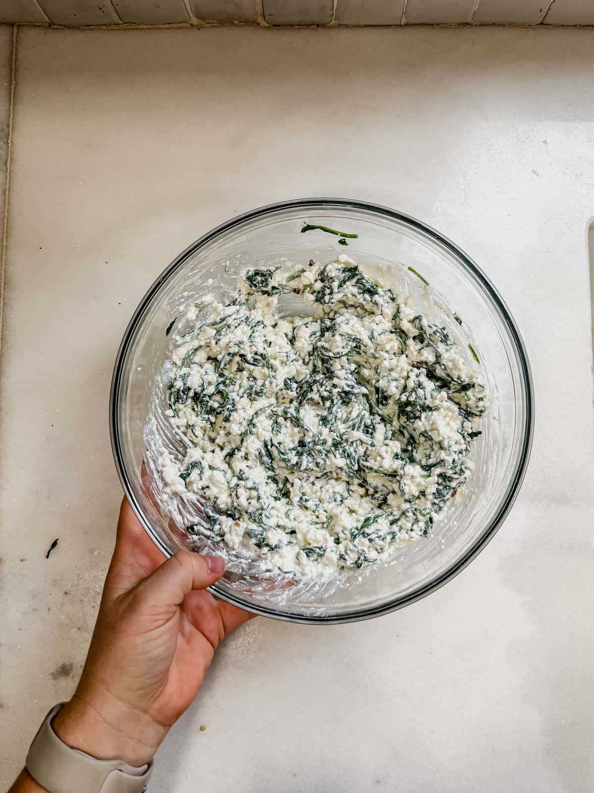 spinach and ricotta mixture in a mixing bowl.