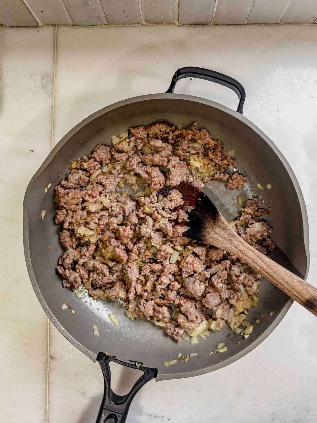 browned beef and italian sausage in a skillet.