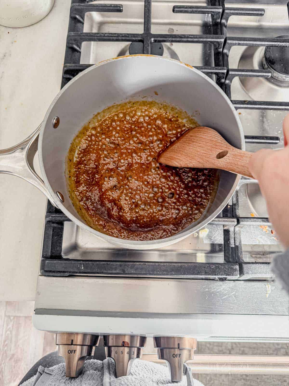 pork tenderloin glaze simmering in a pot on the stove.