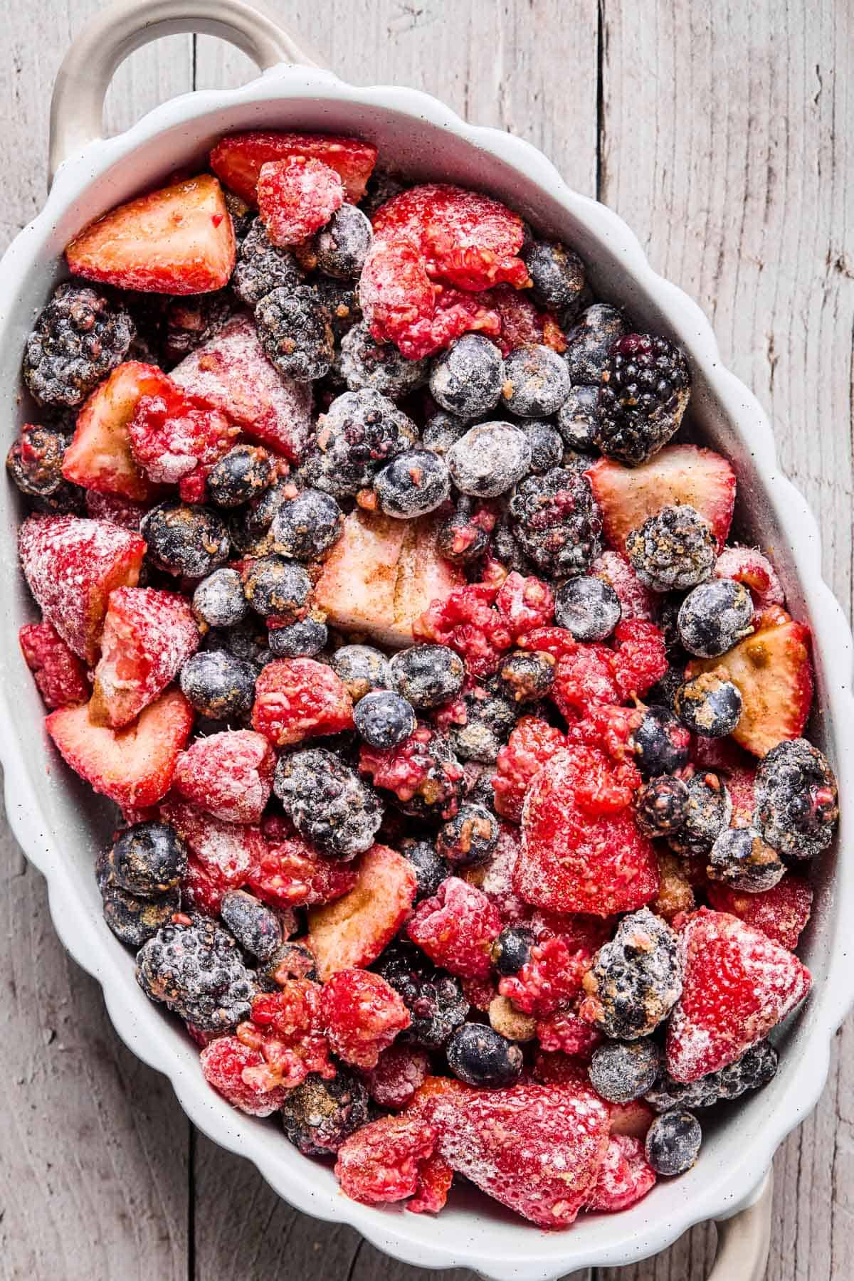 berry, sugar, flour mixture added to a baking dish and set aside for gluten free berry crisp