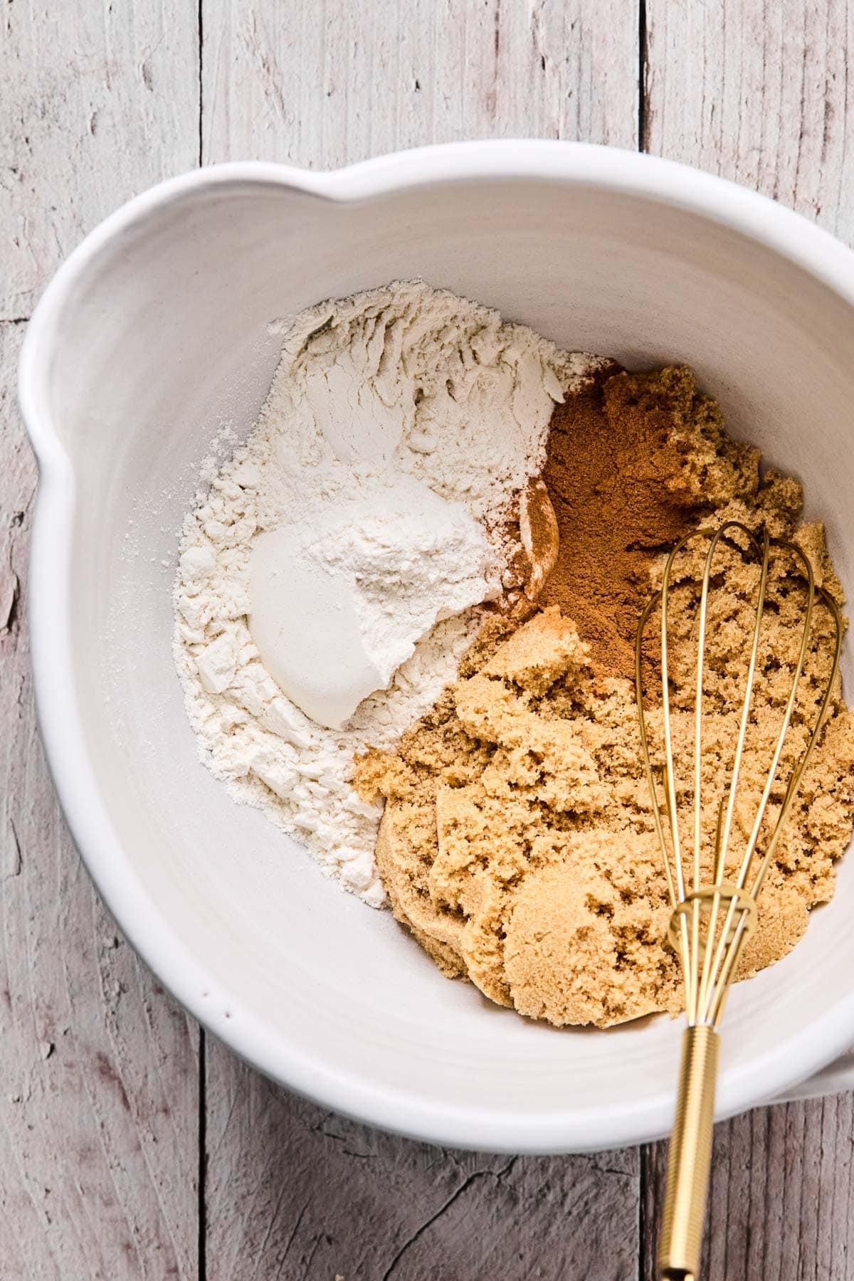 flour, brown sugar, and cinnamon being whisked together for gluten free berry crisp topping