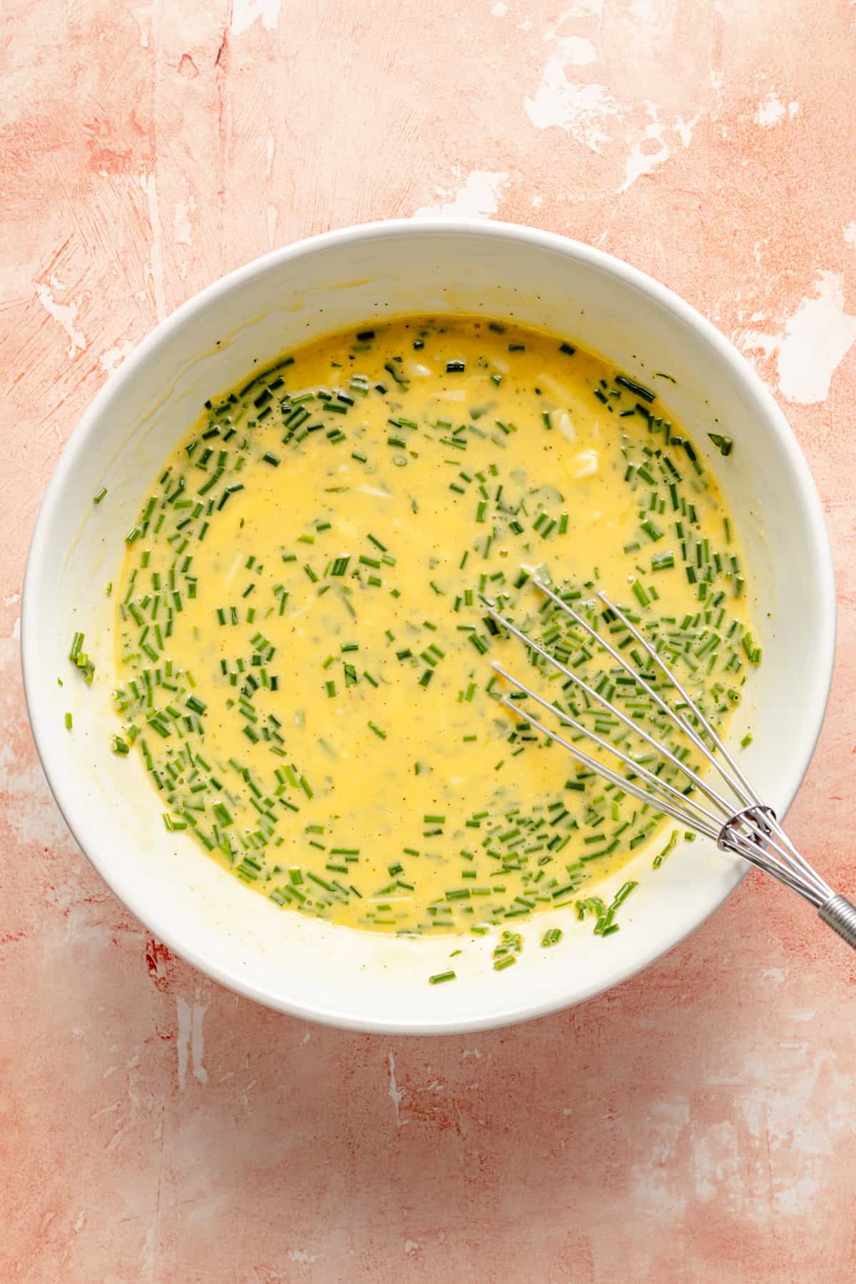 eggs whisked in a bowl with veggies