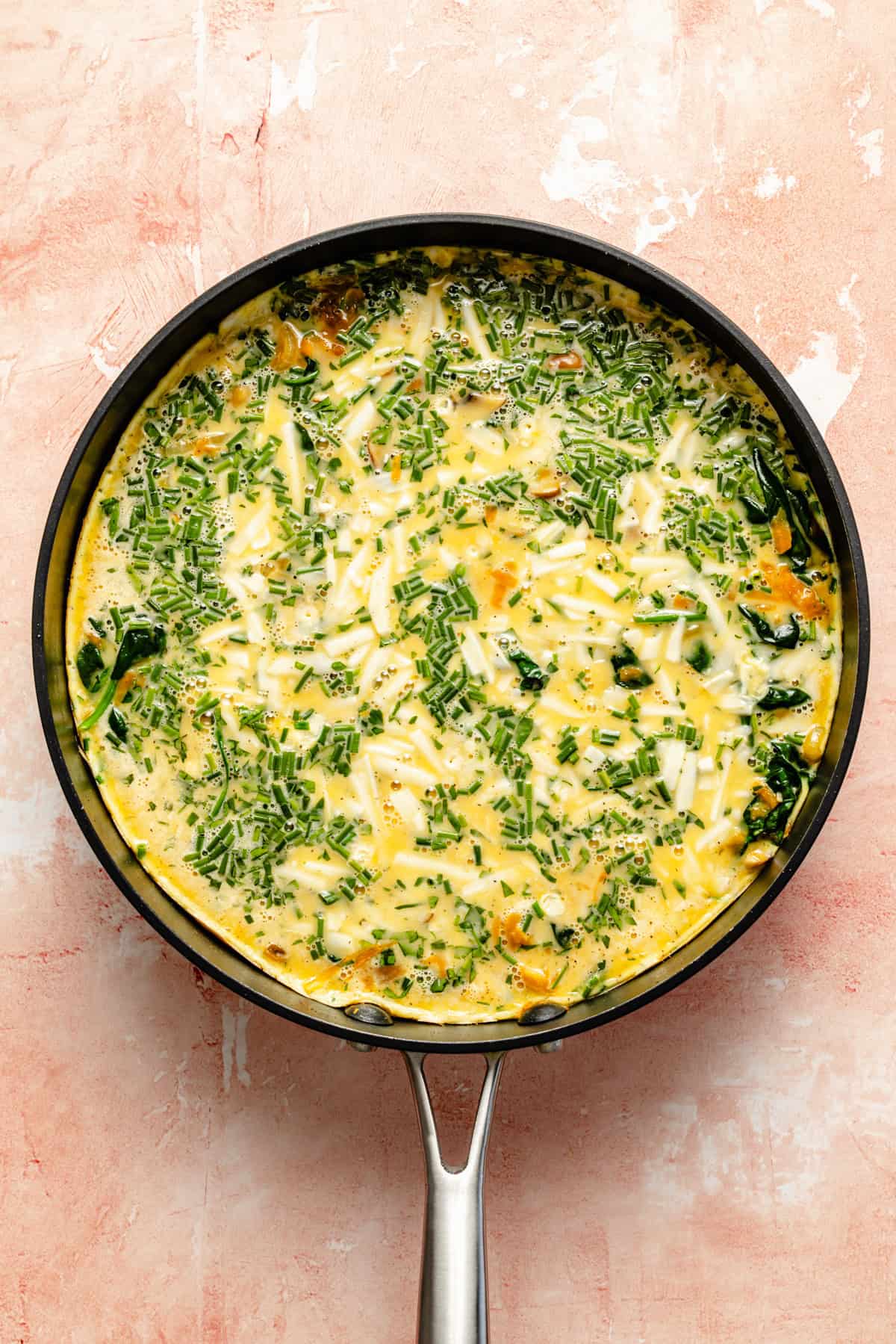 egg mixture and sauteed veggies combined in a nonstick skillet