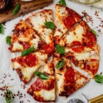 cottage cheese pizza crust with cheese and pepperoni sliced into pieces.