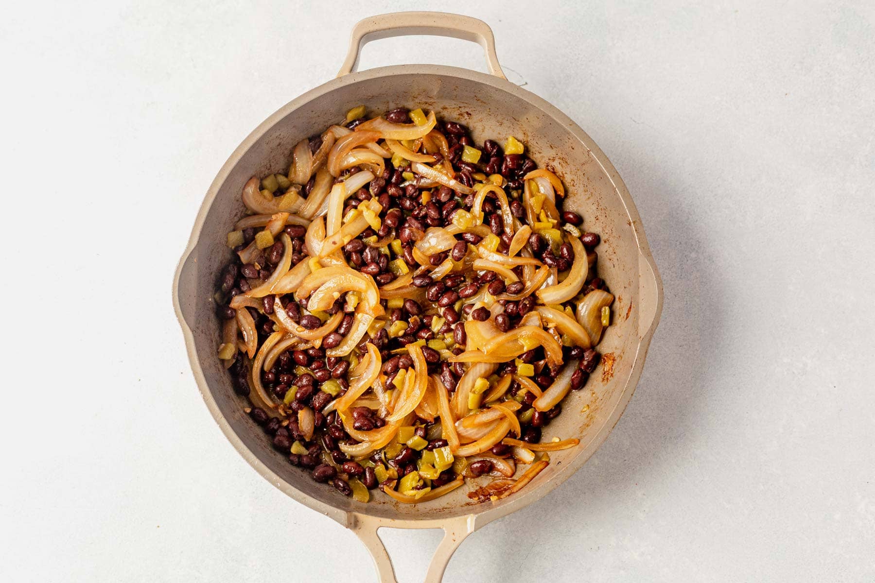 black beans, sliced onions, and green chiles sauted in a skillet