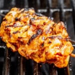 bang bang chicken skewers cooking on the grill.