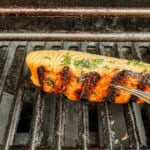 Salmon fillets on grill flesh-side down—step 2 of recipe.