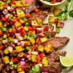 grilled flank steak with pineapple salsa on top