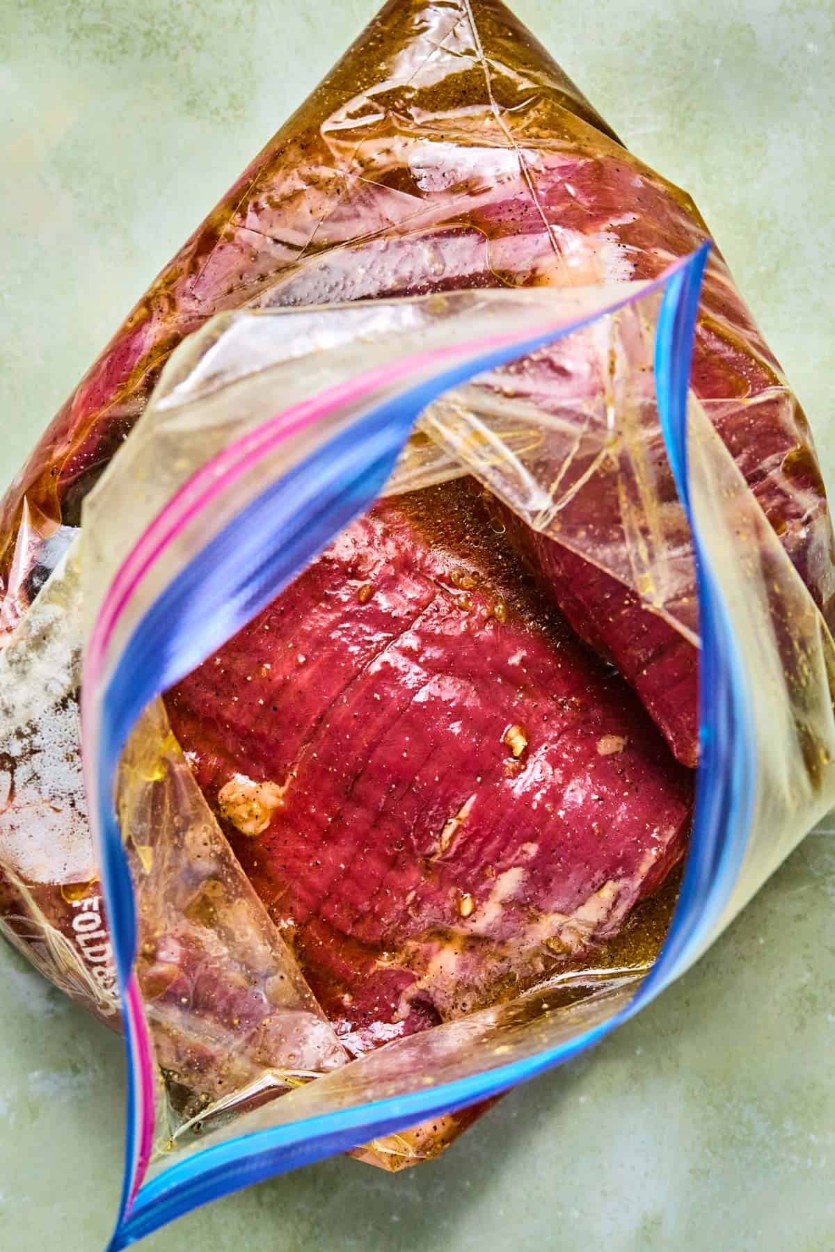 flank steak in a ziploc bag wtih marinade