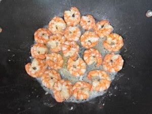 seared shrimp cooked in a wok.