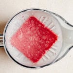 Cream, yogurt, strawberry jam, and freeze dried strawberries blended for strawberry shortcake ice cream bars.