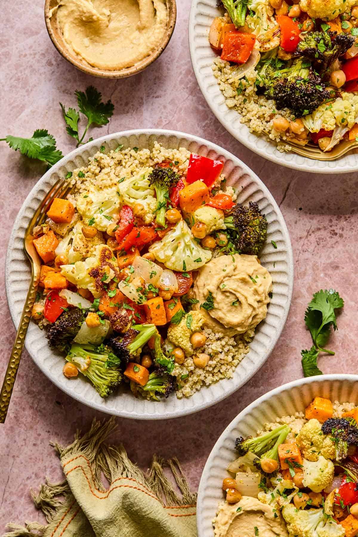 roasted vegetable quinoa bowl on a table in a white bowl
