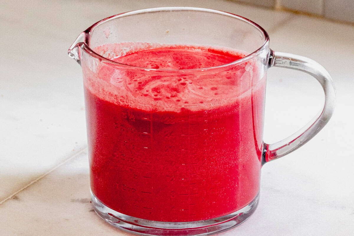 watermelon vodka cocktails in a glass pitcher topped with soda water.