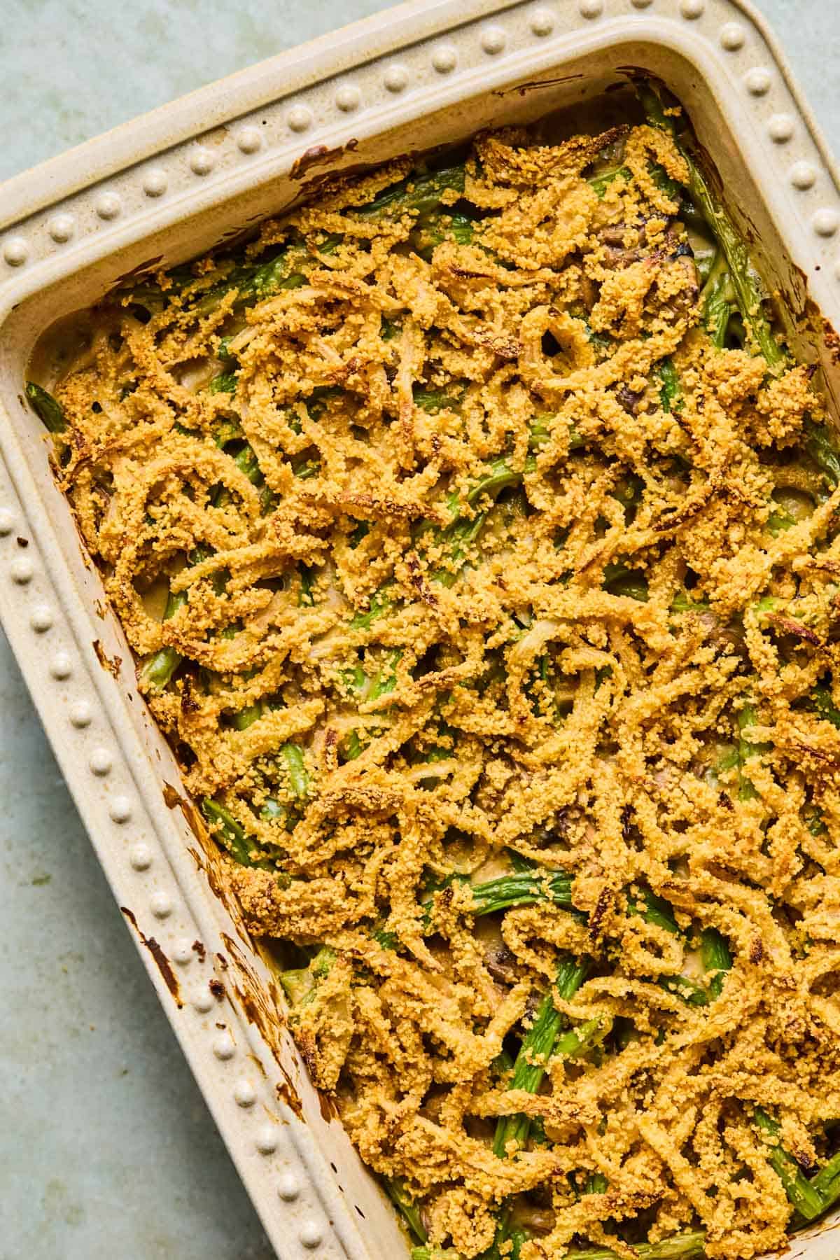 gluten-free dairy-free green bean casserole topped with crispy onions and baked in the oven.