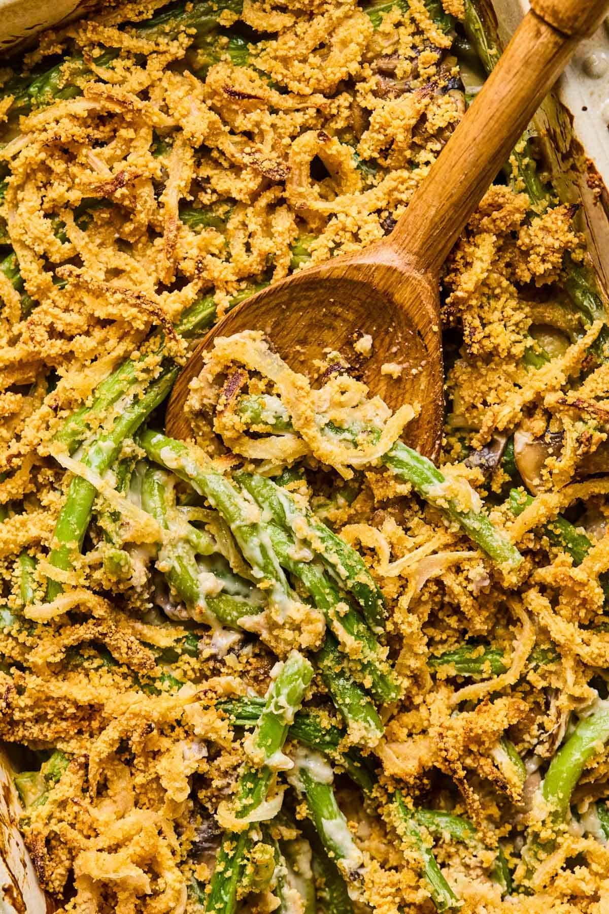 wooden spoon digging into gluten free dairy free green bean casserole