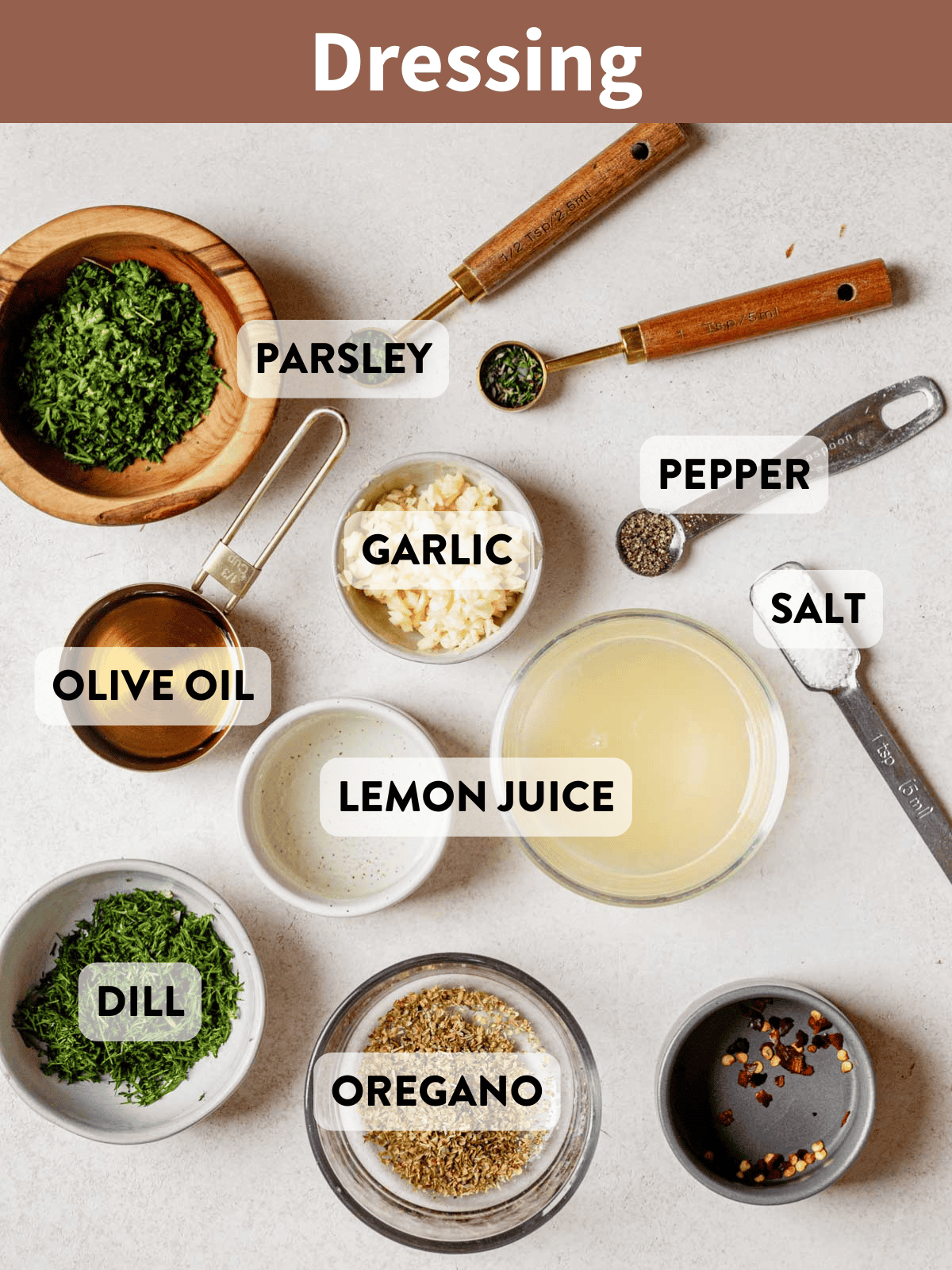Overhead shot of fresh herbs, spices, oil, and lemon juice ingredients for salmon salad dressing.
