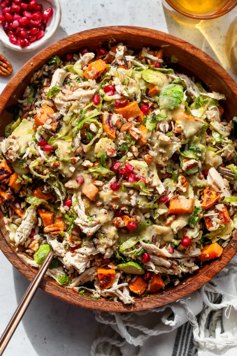 fall harvest brussels sprout salad in a wood bowl.