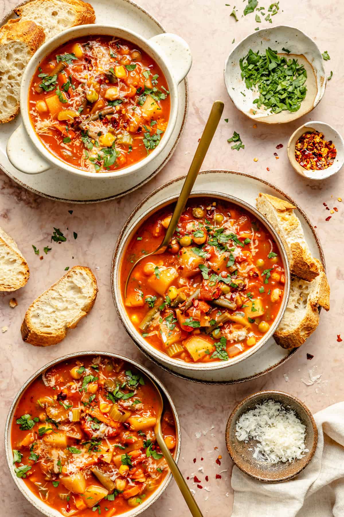 three bowls of easy vegetable soup sitting on a counter.