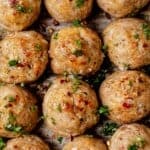 Juicy golden brown baked turkey meatballs on a sheet pan.
