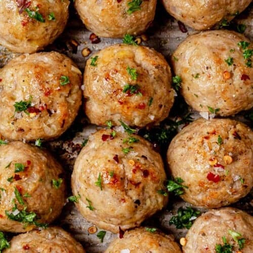 Juicy golden brown baked turkey meatballs on a sheet pan.