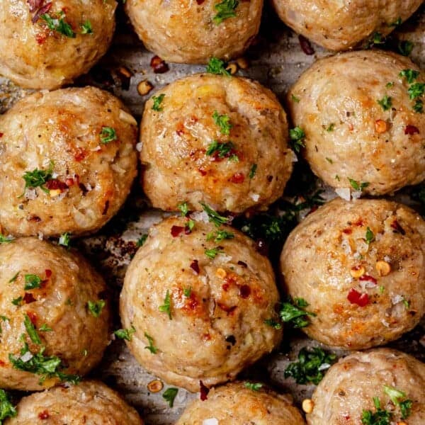 Juicy golden brown baked turkey meatballs on a sheet pan.