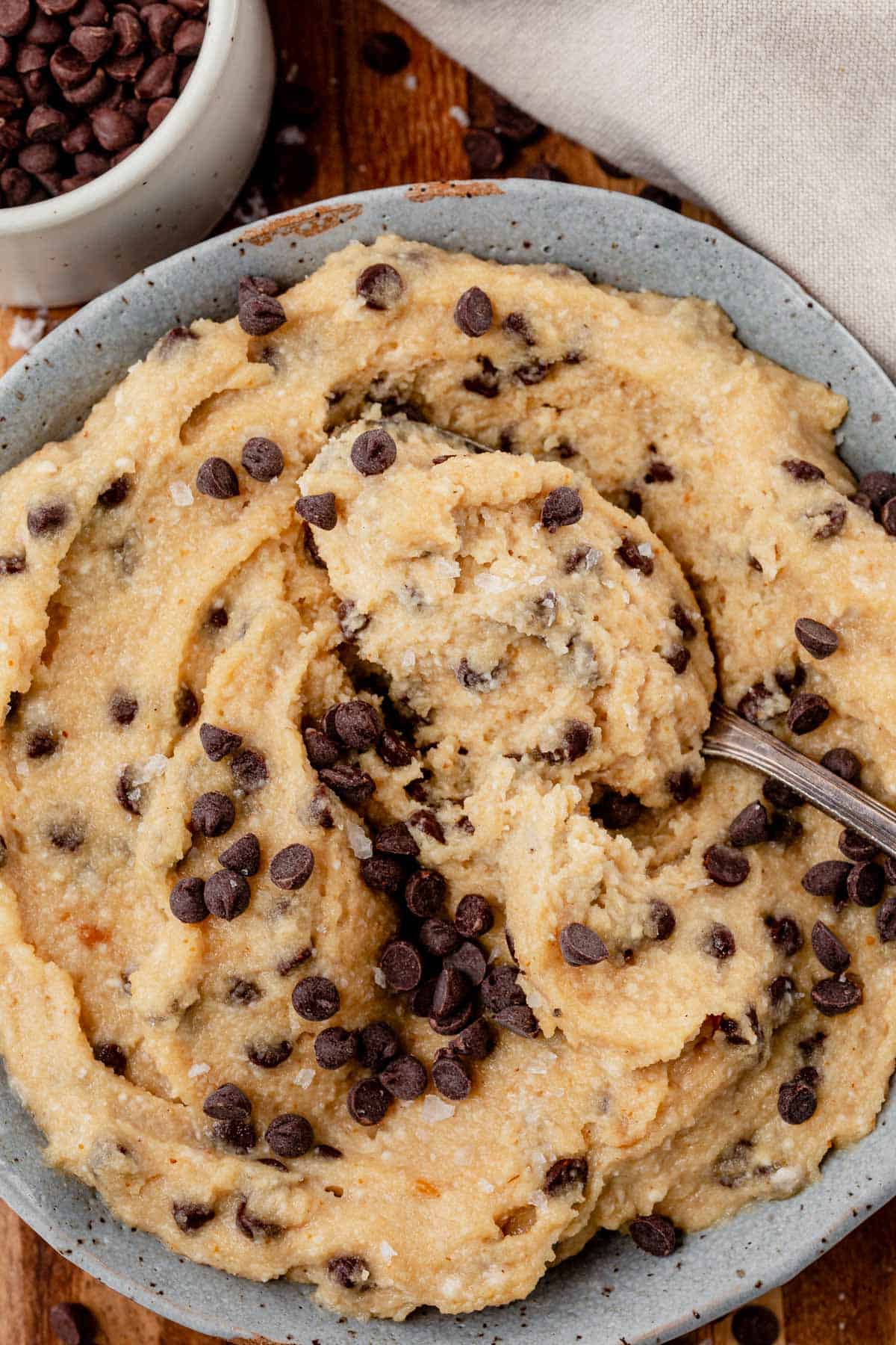 Overhead shot of a bowl of cottage cheese cookie dough with chocolate chips stirred in.