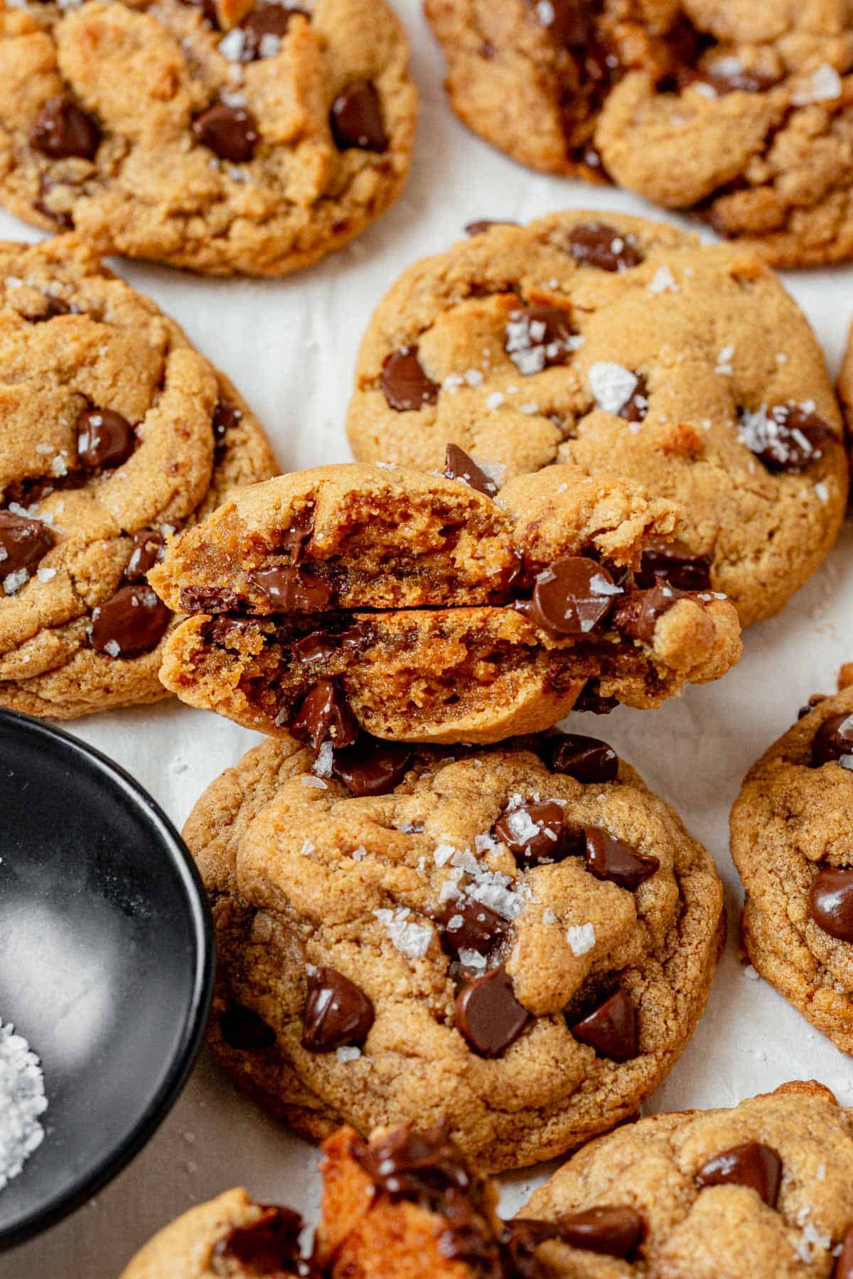 a protein cookie broken in half to see the soft center and gooey chocolate chips.
