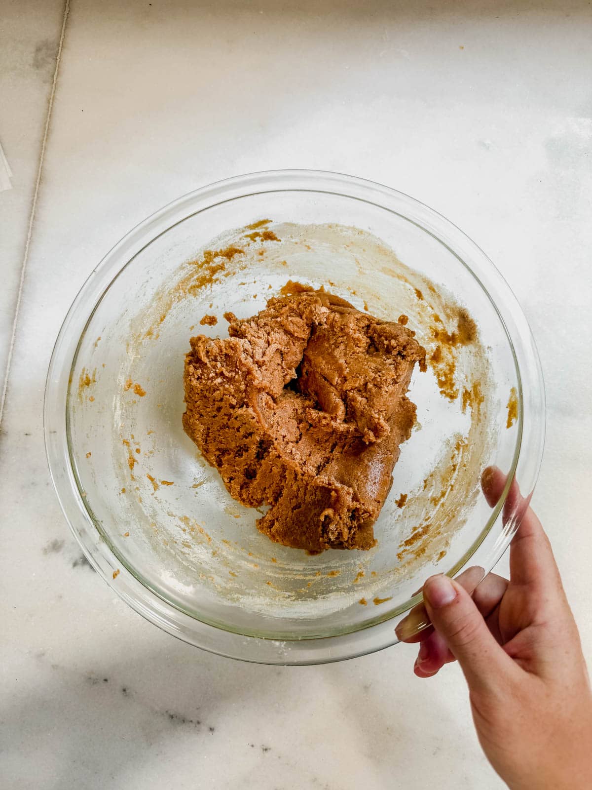 protein cookie dough mixed in a bowl on the counter.