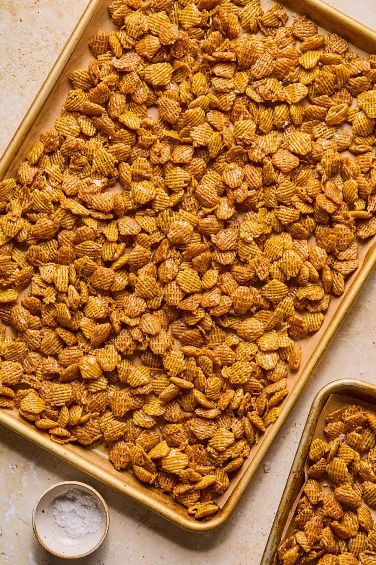 crispix mix added to a baking sheet to cool completely.