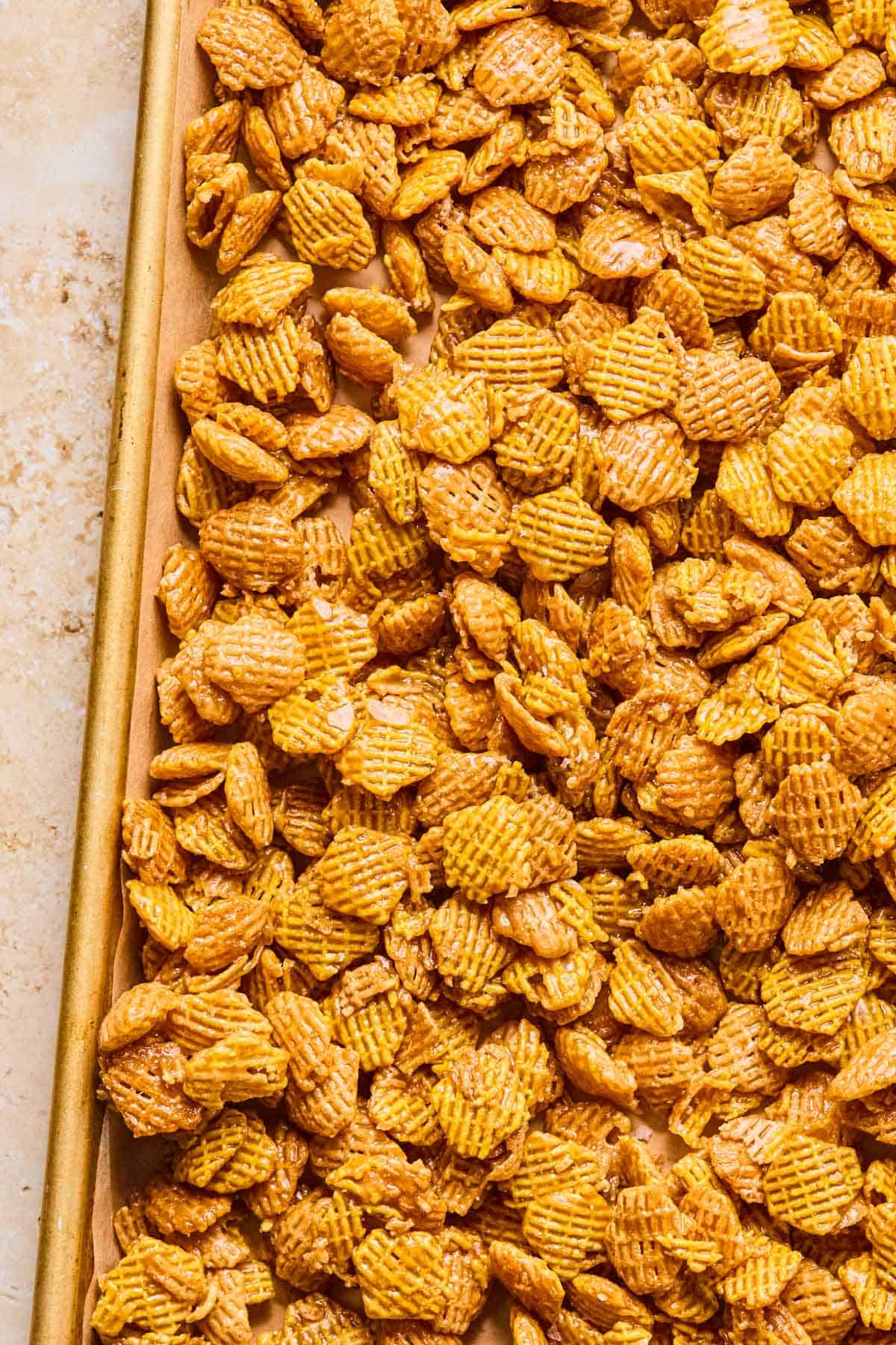 salted caramel crispix mix on a baking sheet