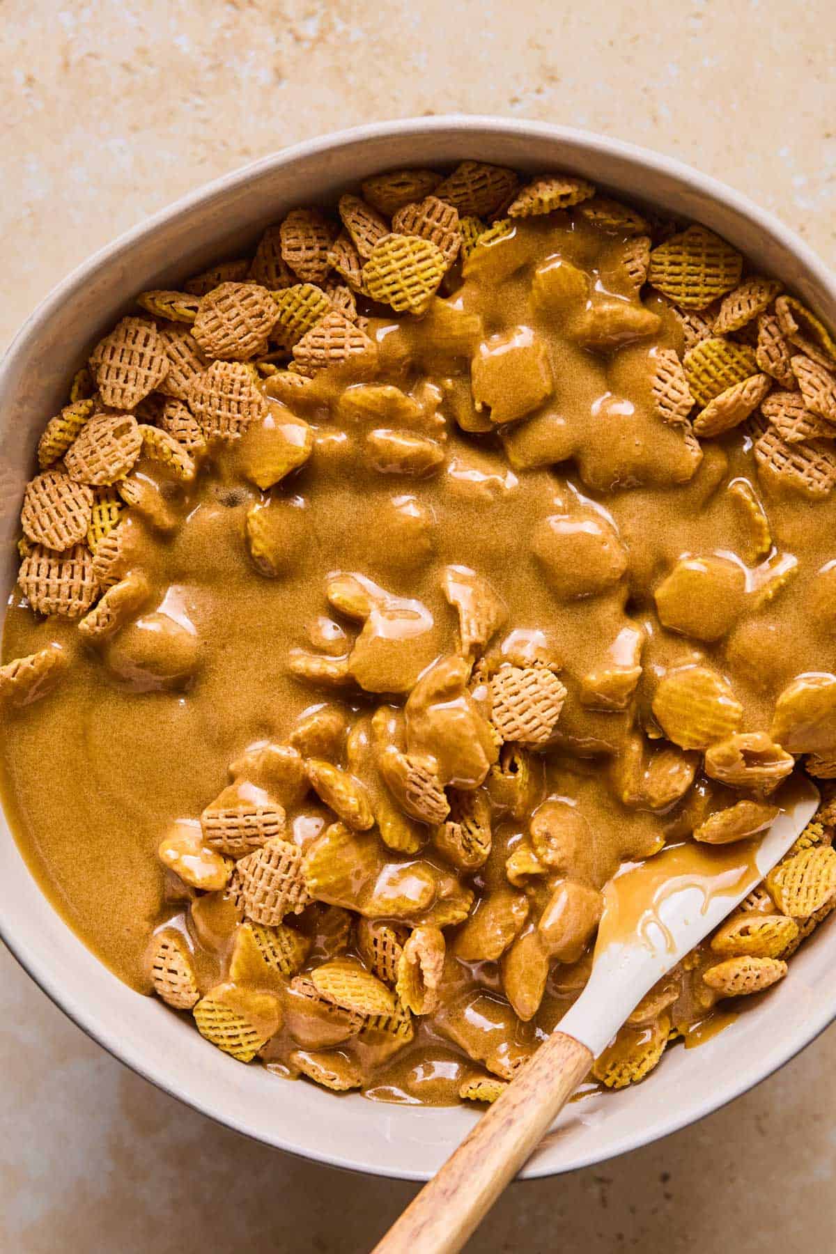 Add the caramel mixture to the prepared Crispix and stir gently with a rubber or wooden spatula