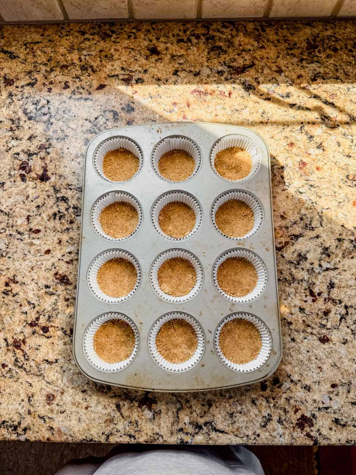 graham cracker crust pressed into muffin tins.