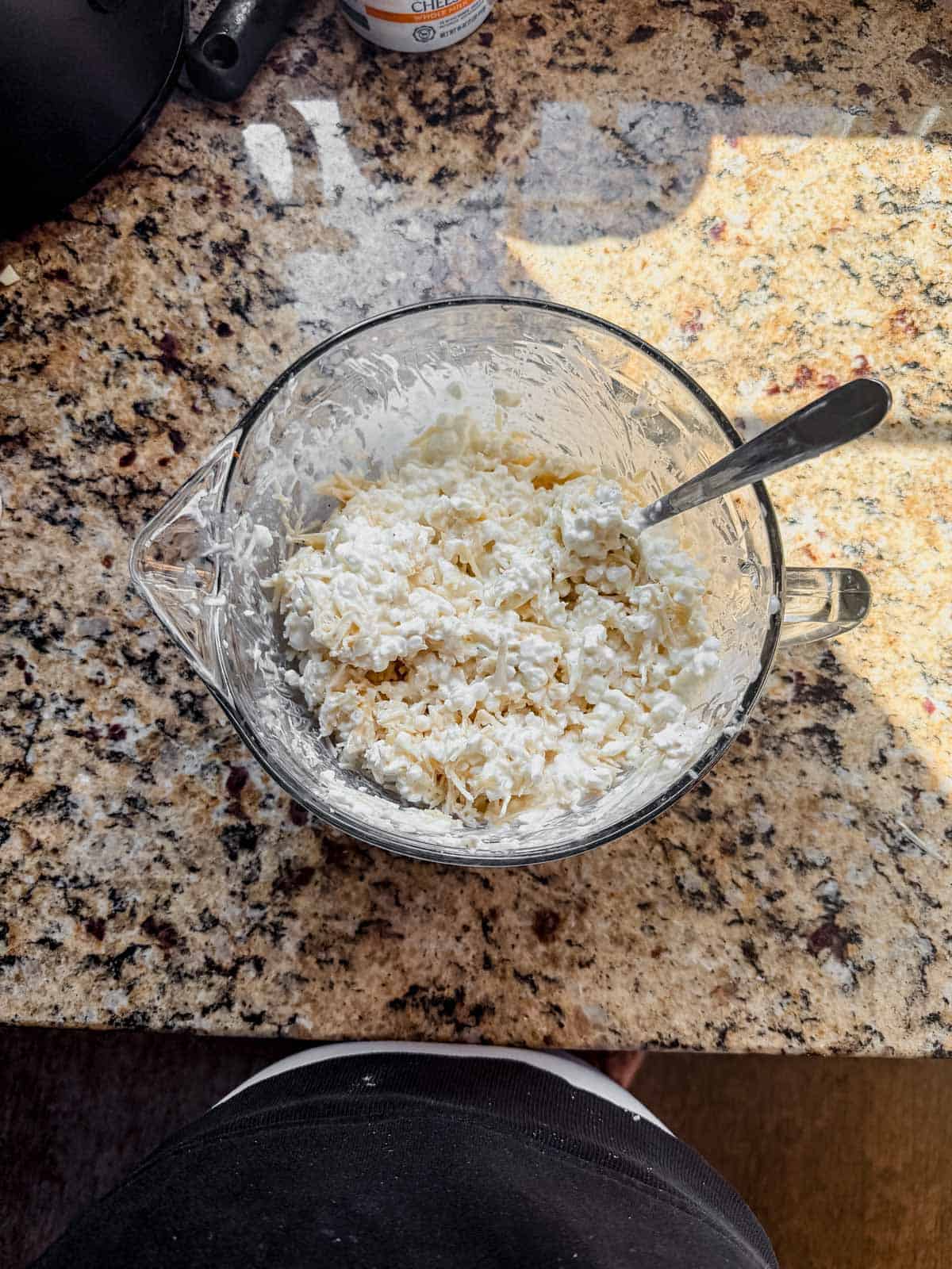 cottage cheese, parmesan cheese, salt, and pepper mixed in a glass bowl.