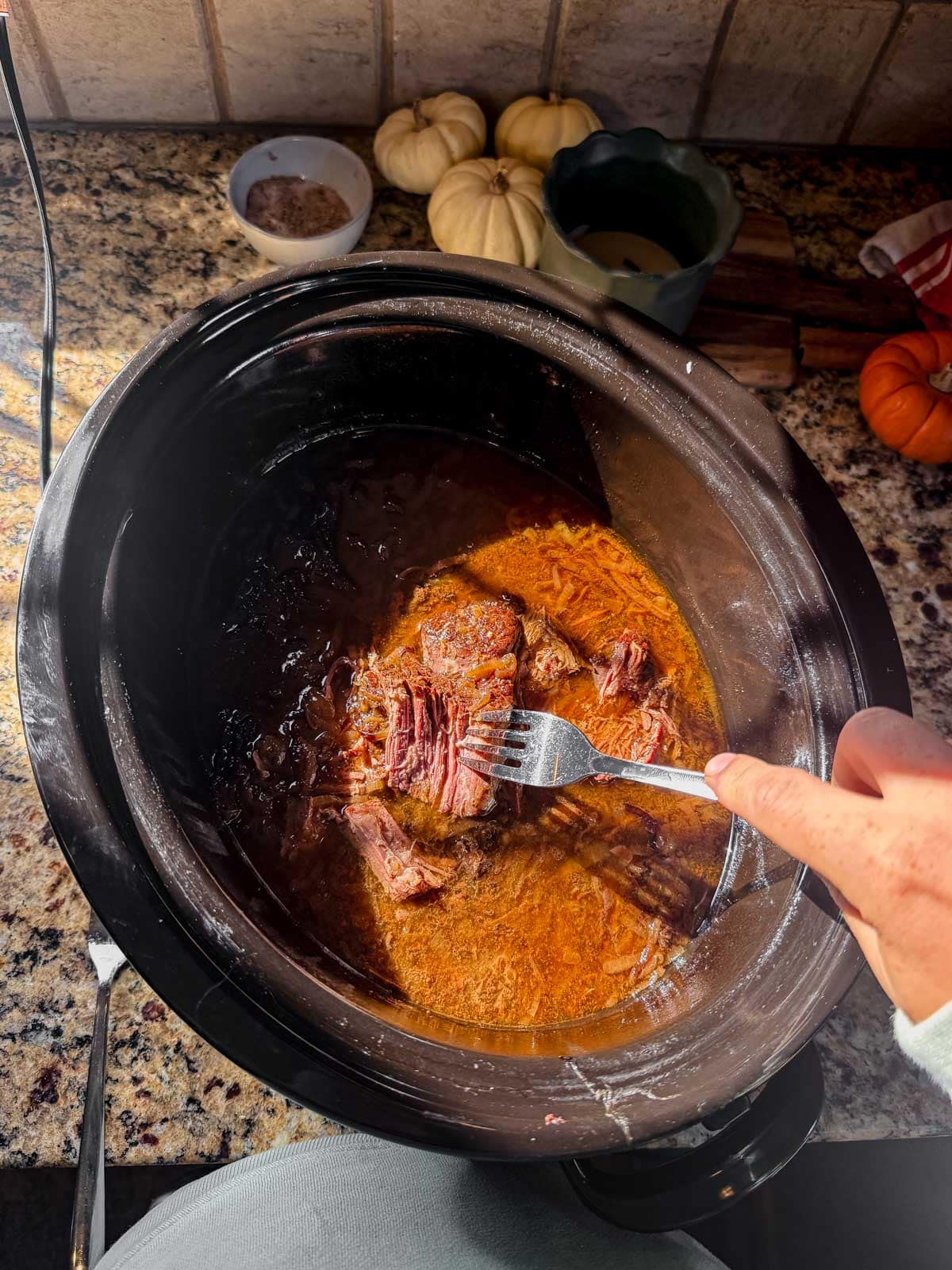 shredded french onion pot roast with a fork.