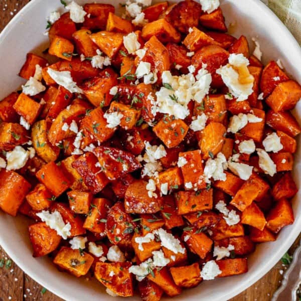 honey roasted sweet potatoes in a serving bowl topped with feta.
