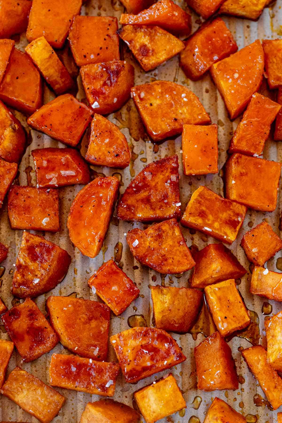 caramelized honey roasted sweet potatoes on a sheet pan.