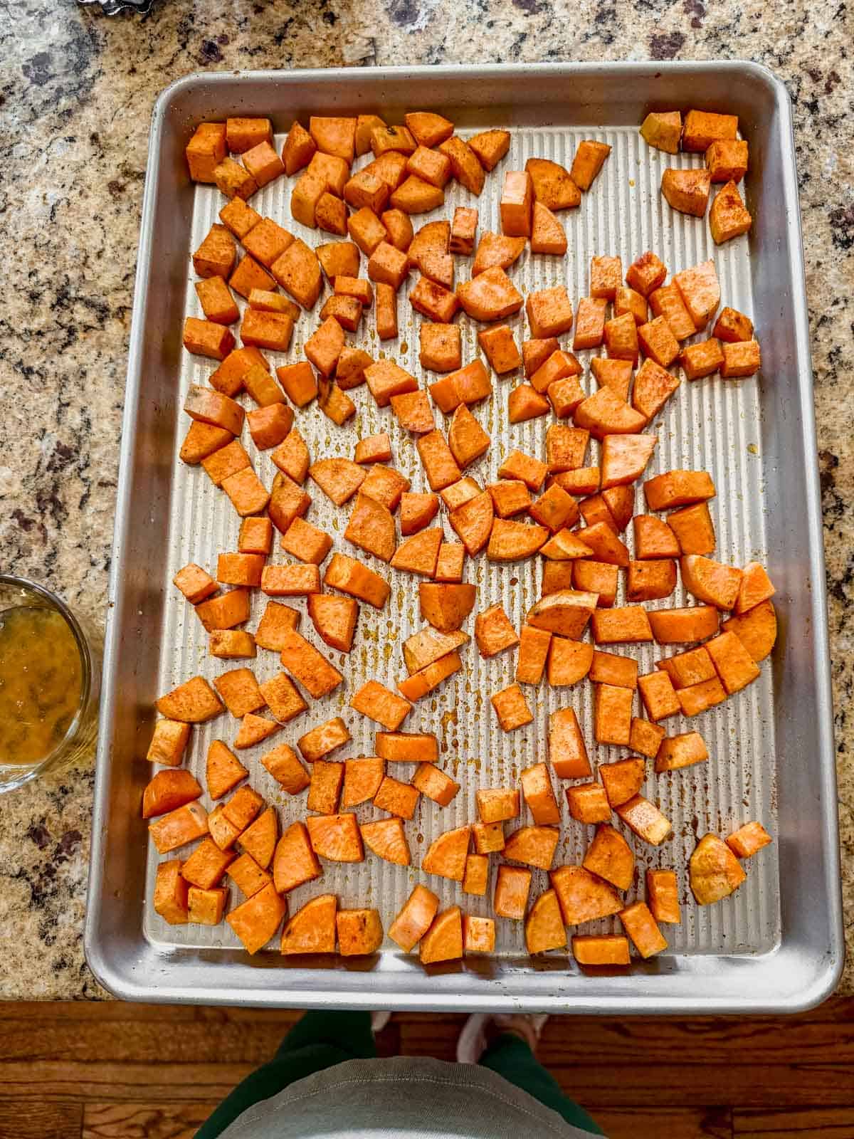 roasted sweet potatoes with honey and spices on a sheet pan.