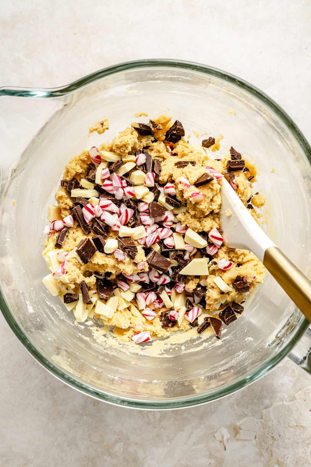 stirring chopped semi-sweet chocolate, white chocolate, and crushed candy canes into cookie dough.