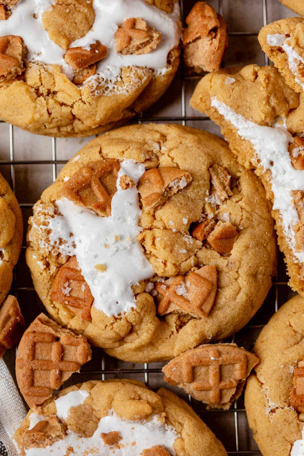 fluffernutter cookies and large chunks of nutter butter cookies laying on a cooling rack.