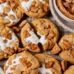 fluffernutter cookies laying out on a cooling rack with the middle cookies split in two with marshmallow fluff stretched between the two pieces.
