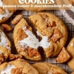 fluffernutter cookies laying on a counter and the middle one broken in half