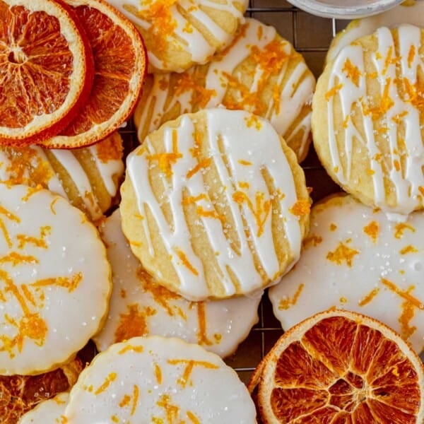 orange shortbread cookies with orange glaze on a counter.