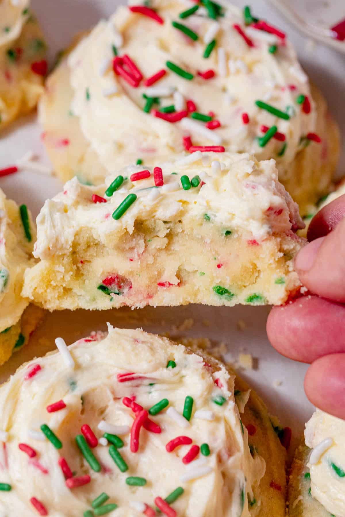 a thick and soft frosted christmas cookie with a bite missing to see the extra soft centers.