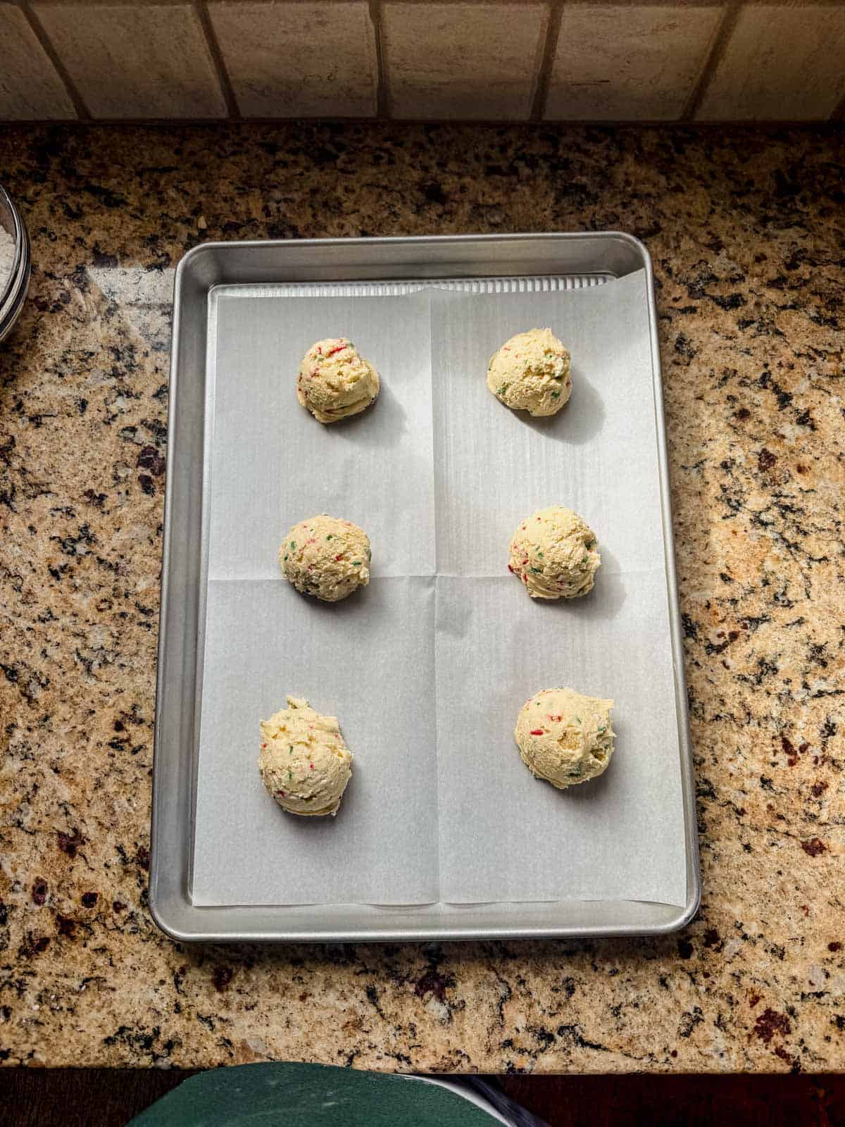 soft christmas sugar cookie dough scooped onto a baking sheet.