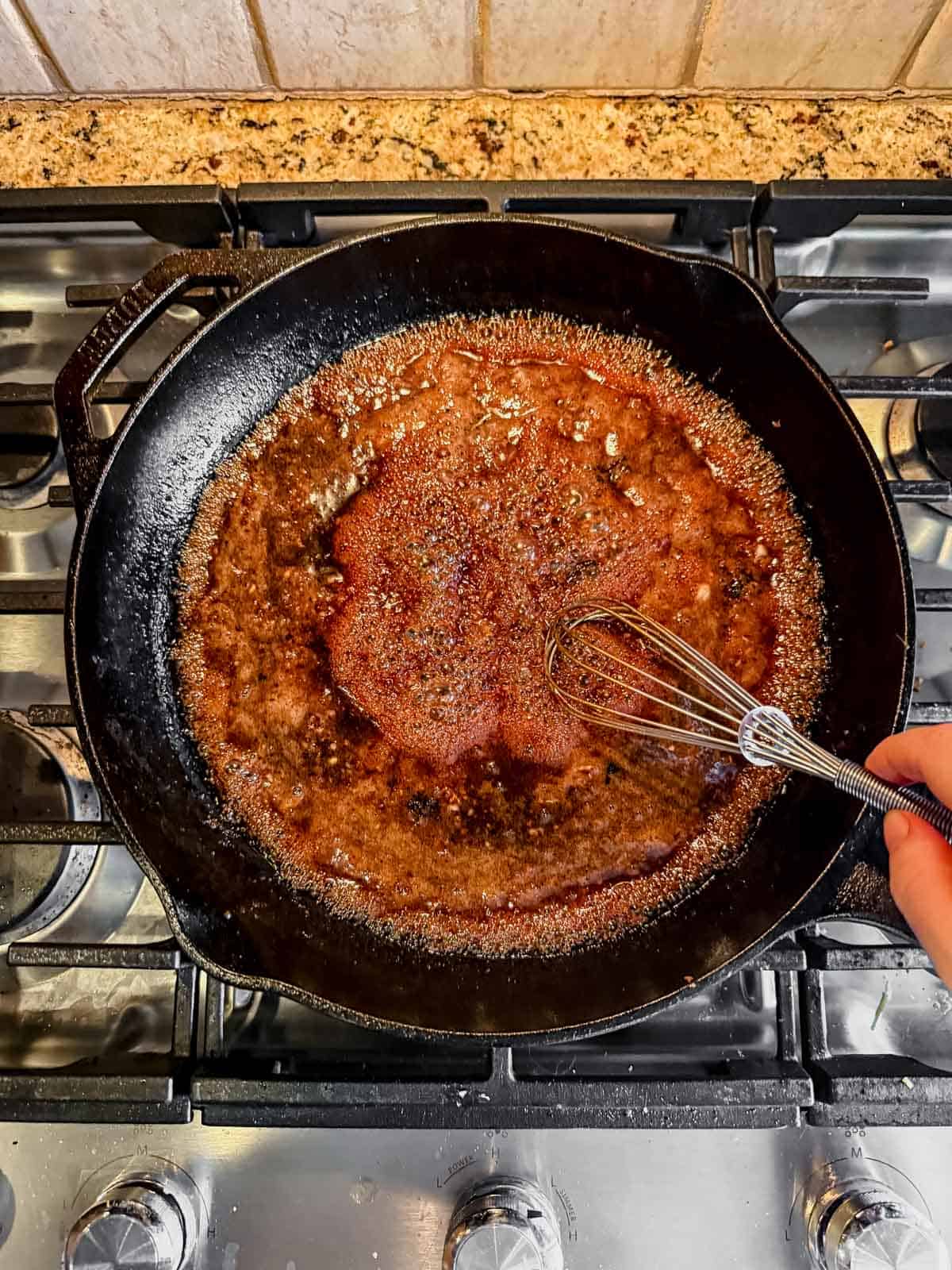 simmering honey garlic sauce on the stove until thickened.