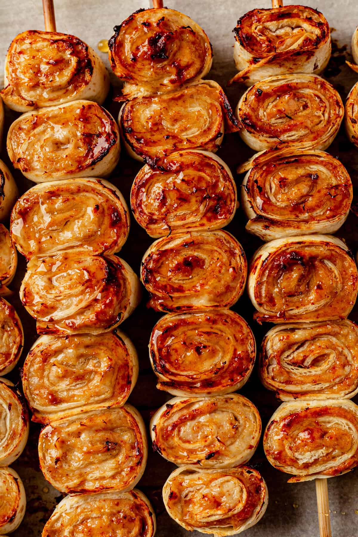 lazy kebab rolls on wooden skewers brushed with hot honey.