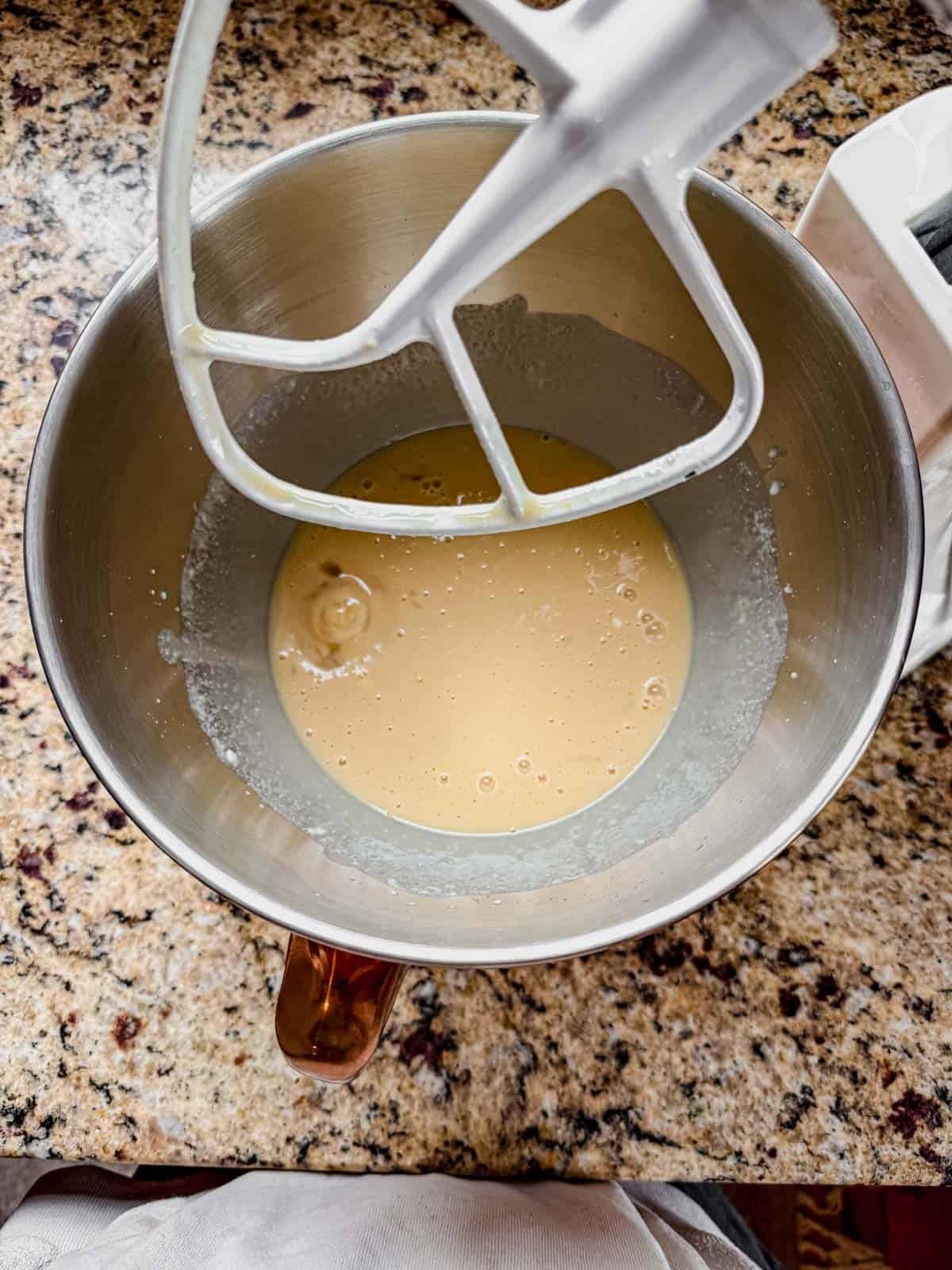 wet ingredients for cinnamon rolls in a stand mixer.