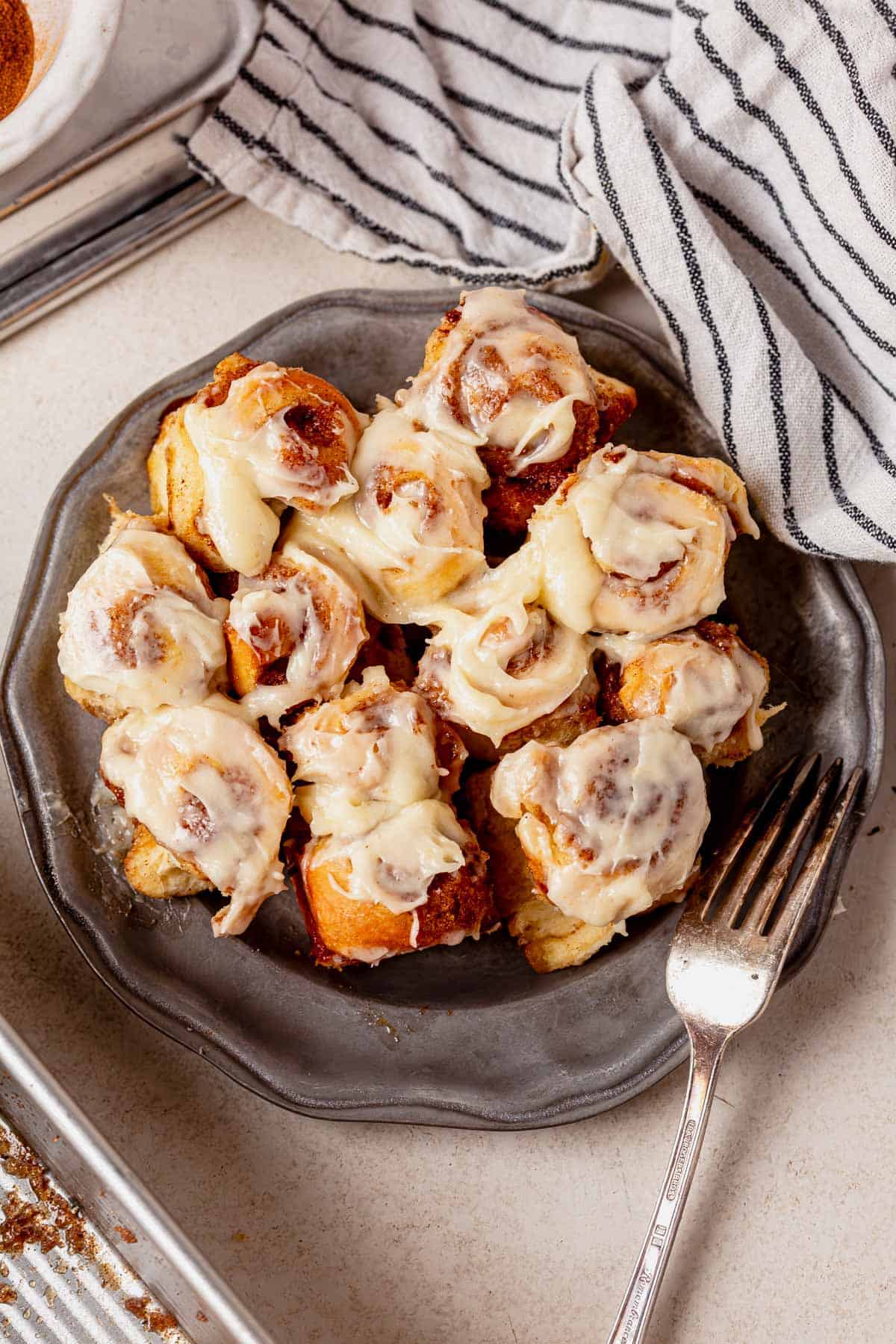 a plate of mini cinnamon rolls with a fork.