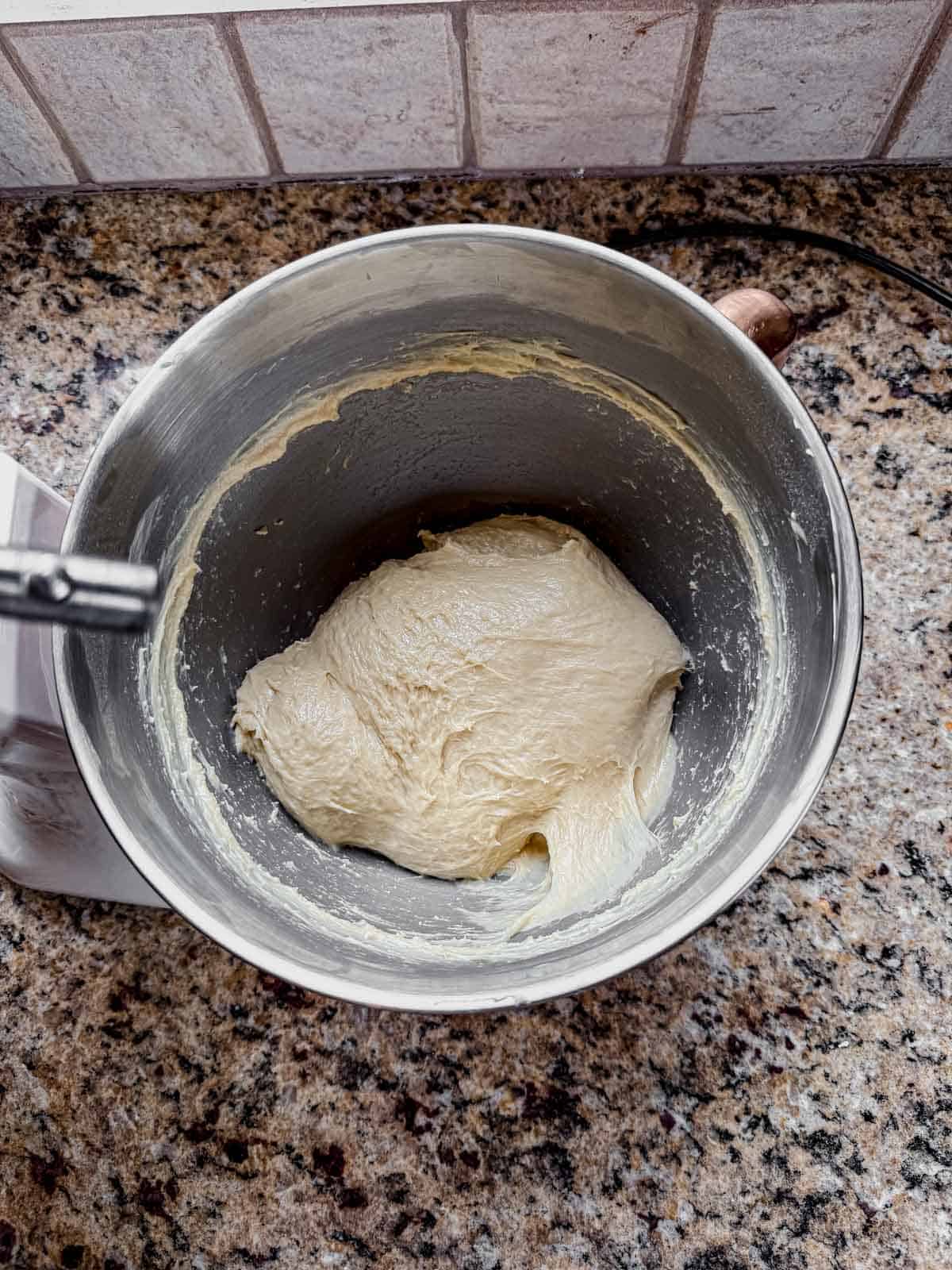 cinnamon roll dough ball after adding butter and kneading.