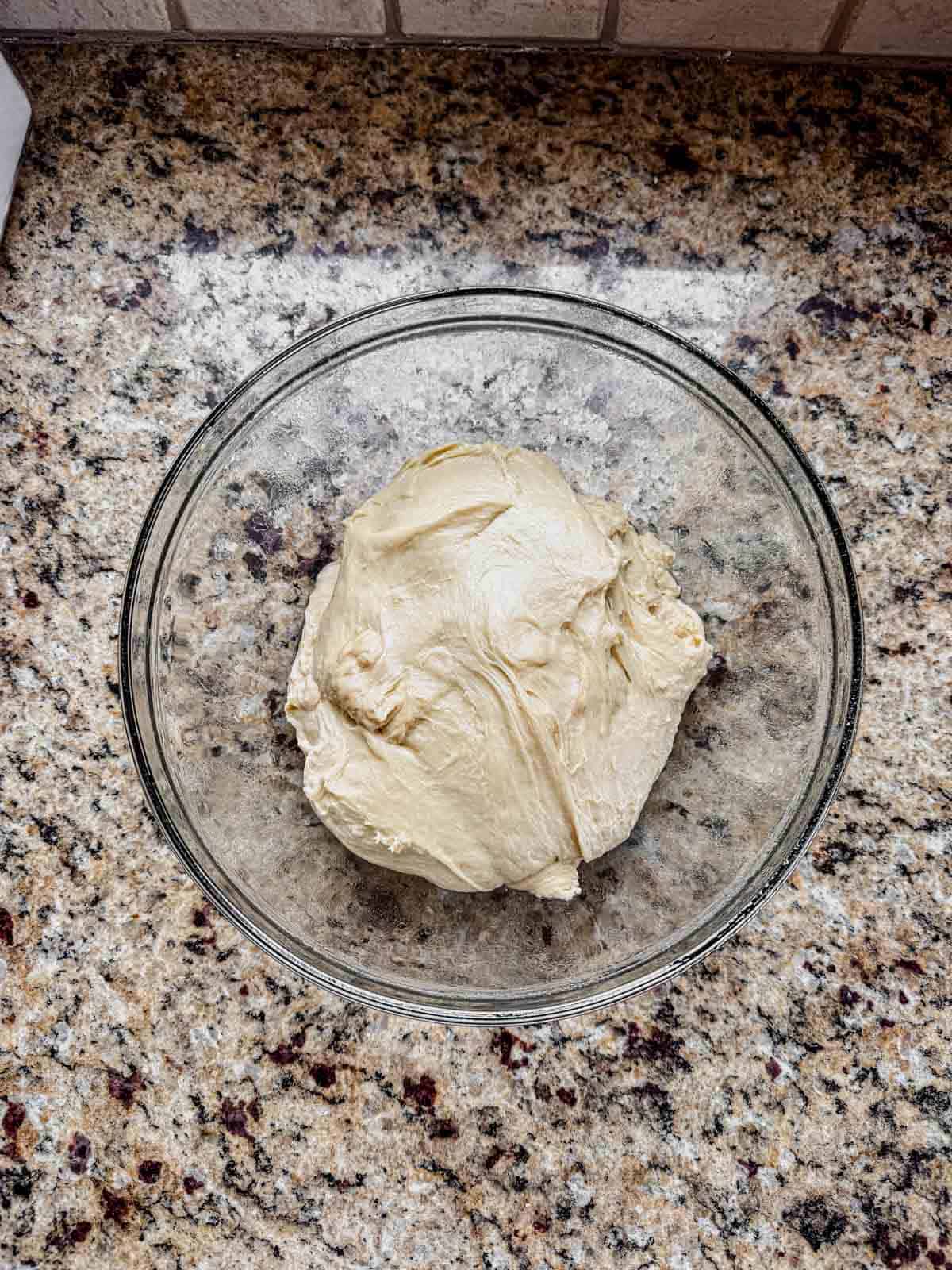 cinnamon roll enriched dough in a greased glass bowl before rising.